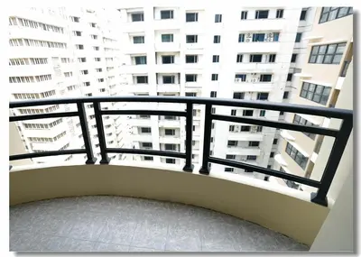a balcony with a view of a tall building at Golden Seagulls Hotel in Manila
