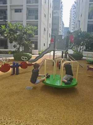 two children playing on a playground in a city at Zeki's Place - Shore 2 Residences MOA in Manila
