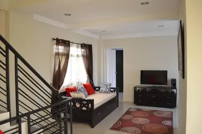a living room with a couch and a television at Home in Pasig in Manila