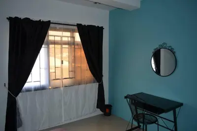 a room with a window with a table and a mirror at Home in Pasig in Manila
