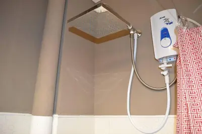 a shower with a shower head in a bathroom at Home in Pasig in Manila