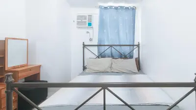 a small bed in a room with a mirror at Lascianos SMDC Shore Residences by RedDoorz in Manila
