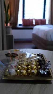 a tray of food on a table in a hotel room at Air residence Fantasy Sophisticated Chic Family living 300 Mbps Fast in Manila