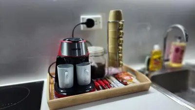 a coffee maker in a tray on a kitchen counter at Air residence Fantasy Sophisticated Chic Family living 300 Mbps Fast in Manila