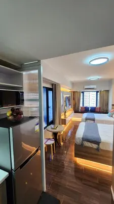 a bedroom with a bed and a kitchen in a room at Air residence Fantasy Sophisticated Chic Family living 300 Mbps Fast in Manila