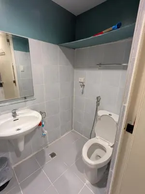 a bathroom with a toilet and a sink at Eriel condotel in Manila