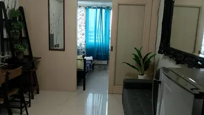 a living room with a hallway with a blue curtain at Eriel condotel in Manila