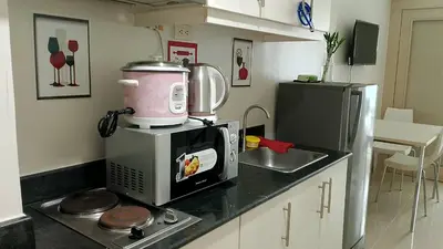 a kitchen with a mixer on top of a microwave at Eriel condotel in Manila