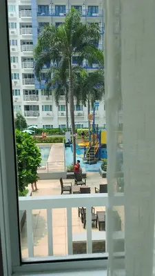 a view of a swimming pool from a window at Eriel condotel in Manila
