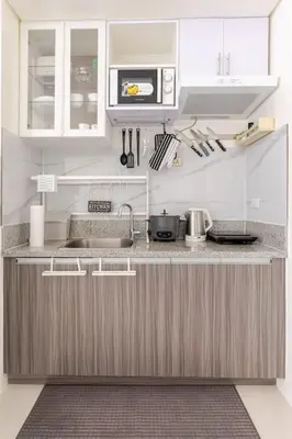 a kitchen with a sink and a microwave at Perfect accommodation for you in Levels Burbank in Manila