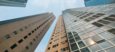 two tall buildings looking up at the sky at Elite Homestays Family-Friendly Condo Near Malls with Pool & Gym in Manila