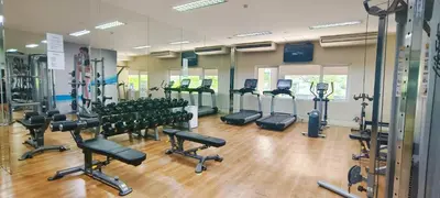 a gym with rows of treadmills and exercise bikes at Elite Homestays Family-Friendly Condo Near Malls with Pool & Gym in Manila