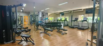 a gym with rows of treadmills and exercise bikes at Elite Homestays Family-Friendly Condo Near Malls with Pool & Gym in Manila