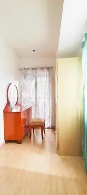 a living room with a table and a mirror at Elite Homestays Family-Friendly Condo Near Malls with Pool & Gym in Manila
