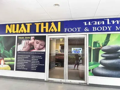 a sign for a knot thai food and body shop at Oasis MOA- Sea Residences in Manila