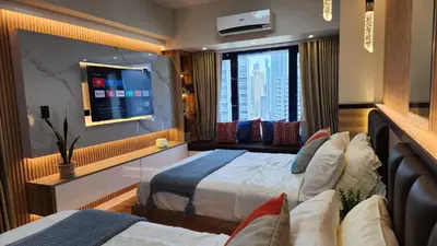 a hotel room with two beds and a window at Air Residence Makati Suite Sophisticated Living Condo 300 Mbps in Manila