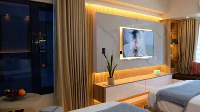 a room with a bed and a tv on a wall at Air Residence Makati Suite Sophisticated Living Condo 300 Mbps in Manila