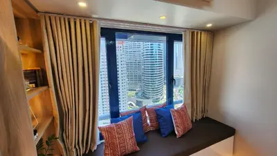 a window with a view of a city skyline at Air Residence Makati Suite Sophisticated Living Condo 300 Mbps in Manila