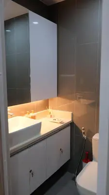 a bathroom with a sink and a mirror and a toilet at Air Residence Makati Suite Sophisticated Living Condo 300 Mbps in Manila