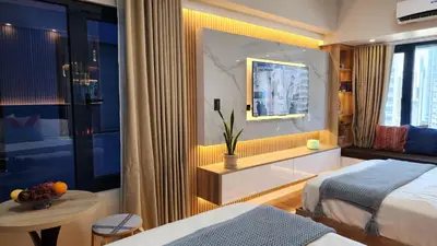 a hotel room with a bed and a table at Air Residence Makati Suite Sophisticated Living Condo 300 Mbps in Manila