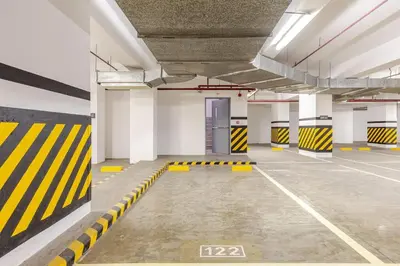 an empty parking garage with yellow and black stripes at Levels Executive Residences in Manila