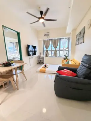a living room with a couch and a ceiling fan at Levels Executive Residences in Manila