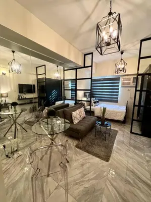 a living room with a couch and a table at Luxury Style Living-Netflix Ready in Manila