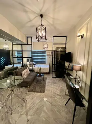 a living room with a couch and a table at Luxury Style Living-Netflix Ready in Manila