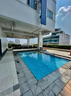 a swimming pool in front of a building at Luxury Style Living-Netflix Ready in Manila