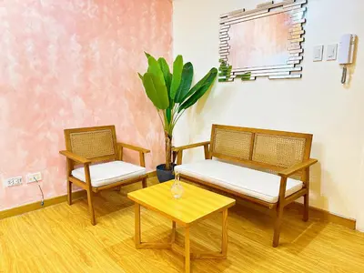 two chairs and a table in a room at 2 Bedroom Summer Themed Unit at Azure in Manila