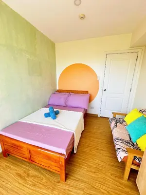 a bedroom with two beds in a room at 2 Bedroom Summer Themed Unit at Azure in Manila