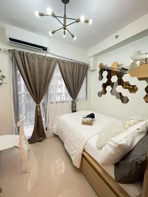 a bedroom with a large bed and a ceiling at Alonas Residences in Manila