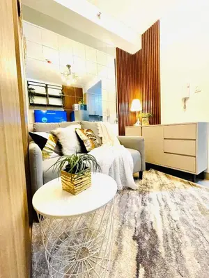 a living room with a couch and a table at Alonas Residences in Manila