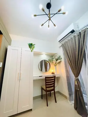 a room with a desk with a mirror and a chair at Alonas Residences in Manila