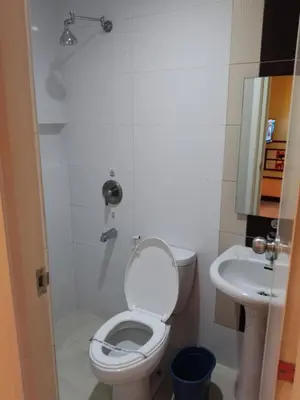 a bathroom with a toilet and a sink at Hotel Sogo - EDSA, Pasay Harrison in Manila