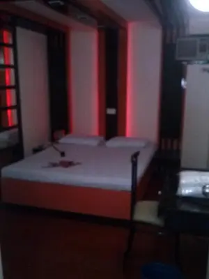a bed in a room with red lighting at Hotel Sogo - EDSA, Pasay Harrison in Manila