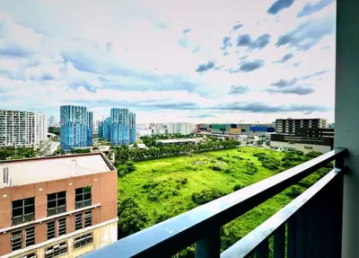 a view of a city from a balcony at Hotel-Like Staycation2 MOA Pasay in Manila