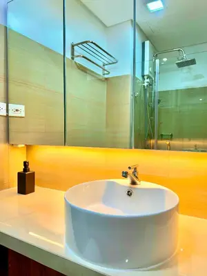 a bathroom with a white sink and a mirror at Hotel-Like Staycation2 MOA Pasay in Manila