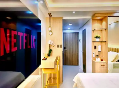 a hotel room with a bed and a desk in it at Hotel-Like Staycation2 MOA Pasay in Manila
