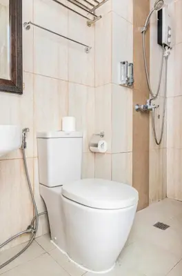 a bathroom with a white toilet and a shower at 8 Adriatico Homestay - S in Manila