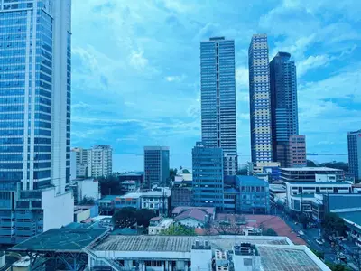 a city skyline with tall skyscrapers and buildings at 8 Adriatico Homestay - S in Manila
