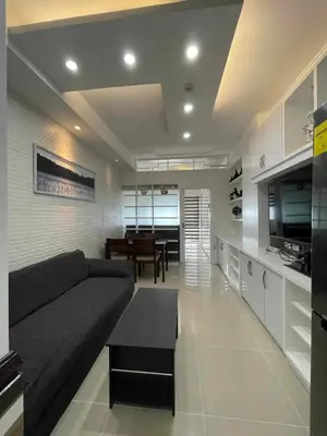 a living room with a couch and a dining room at YAM's WANDERLUST in Manila