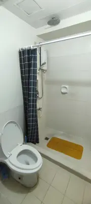 a bathroom with a toilet and a shower at Tivoli Garden Residences, 1 Bedroom unit with sunset view in Manila