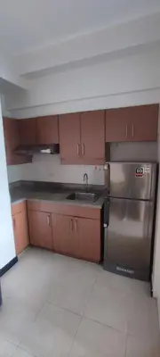 a kitchen with a stainless steel refrigerator and a sink at Tivoli Garden Residences, 1 Bedroom unit with sunset view in Manila