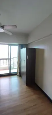 an empty room with a hallway with a large window at Tivoli Garden Residences, 1 Bedroom unit with sunset view in Manila