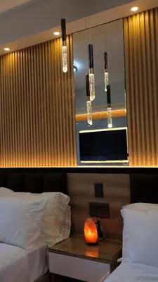 a bedroom with two beds and a table with a mirror at Makati Air Luxury Package - Laugh Sleep Brunch Surf 300 mbps Fast in Manila