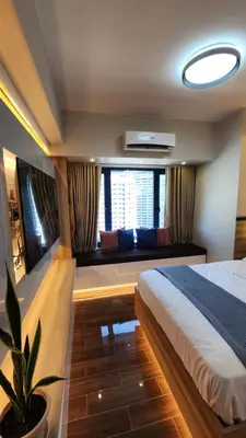 a bedroom with a large bed and a couch at Makati Air Luxury Package - Laugh Sleep Brunch Surf 300 mbps Fast in Manila