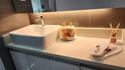 a bathroom counter with a sink and tooth brushes at Makati Air Luxury Package - Laugh Sleep Brunch Surf 300 mbps Fast in Manila