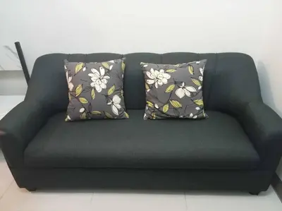 a green couch with two pillows on it at Luxury Bayview Condo MOA & PICC Free WiFi in Manila