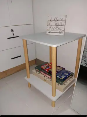 a small white table with wooden legs in a room at Luxury Bayview Condo MOA & PICC Free WiFi in Manila